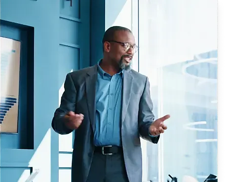 An executive mid-conversation in a glass-walled office