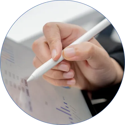 A hand marking up a printed analytics report with a stylus
